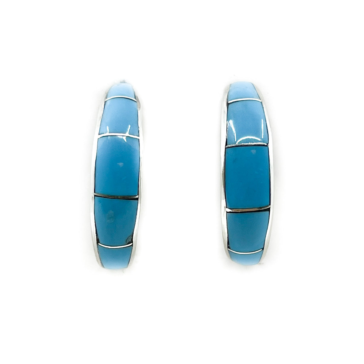 Handcrafted turquoise channel inlay hoop earrings by Zuni artist Philbert Chavez Each earring measures approximately .25 inches in width and 1 inch in diameter Sterling silver posts and backs *All sales on jewelry are final. No returns or exchanges.
