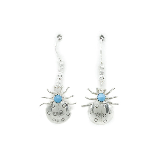 Sterling silver and turquoise ladybug dangle earrings Handcrafted by Lena Platero, Diné jeweler Lightweight, comfortable earring with sterling wires Measures approximately .75 inches long by .25 inches wide, dangles from earlobe 1.25 inches