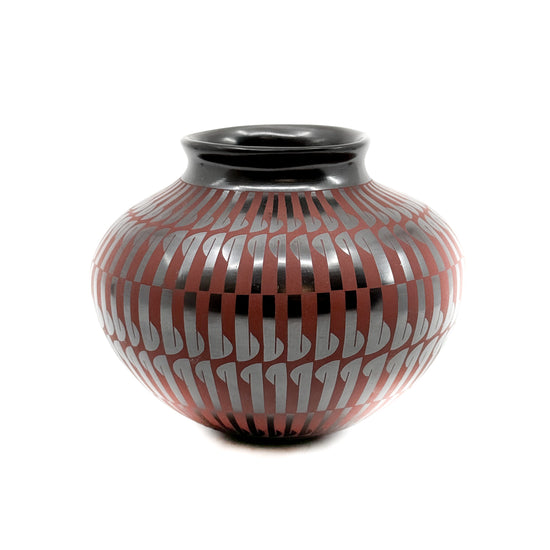Red feather design on high polished black clay Signed on the bottom,&nbsp;Cesar Lucero Measures approximately&nbsp;5.50 inches high x 6 inches in diameter at widest circumference From a private pottery collection procured directly from Mata Ortiz during the mid-1990's.