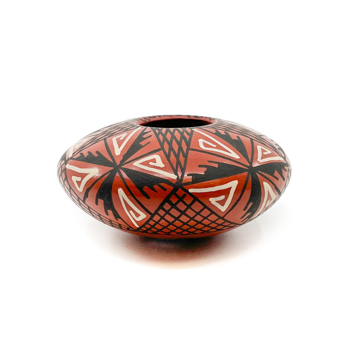 White and Black Geometric Designs on Red Clay