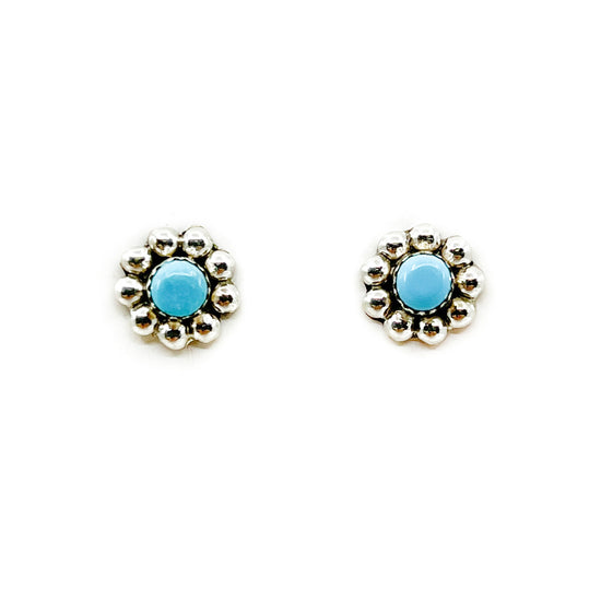 Zuni stud earrings, each with a single turquoise stone set in a sterling silver blossom  By Charlene Cachini, Zuni Measures approximately .25 inches in diameter, sterling silver posts and backs