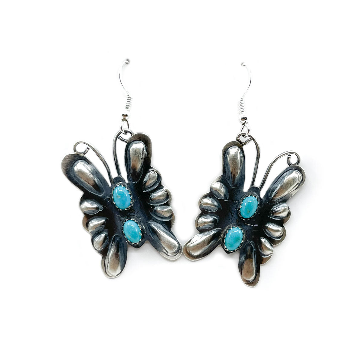 Butterfly earrings handcrafted in sterling silver with soft patina finish and turquoise stones, sterling silver wires
By Tim Yazzie, Diné&nbsp;jeweler
Dimensions: Earrings dangle approx. 2 inches in length and are almost 1 inch wide at wingspan
2 small turquoise cabochons on each earring
Lightweight and comfortable - beautiful!
