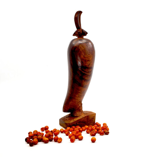 Perfect for crushing your favorite, fiery little chiltepins Carved&nbsp;from Ironwood, made in Sonora, Mexico Approx. 6 to 7 inches tall, including crusher  Top lifts off to grind dried chiles. Crusher is not flush with the chile pepper carving - it is raised up for ease in grinding Size and shape will vary as each is handmade Sold individually, peppers are not included
