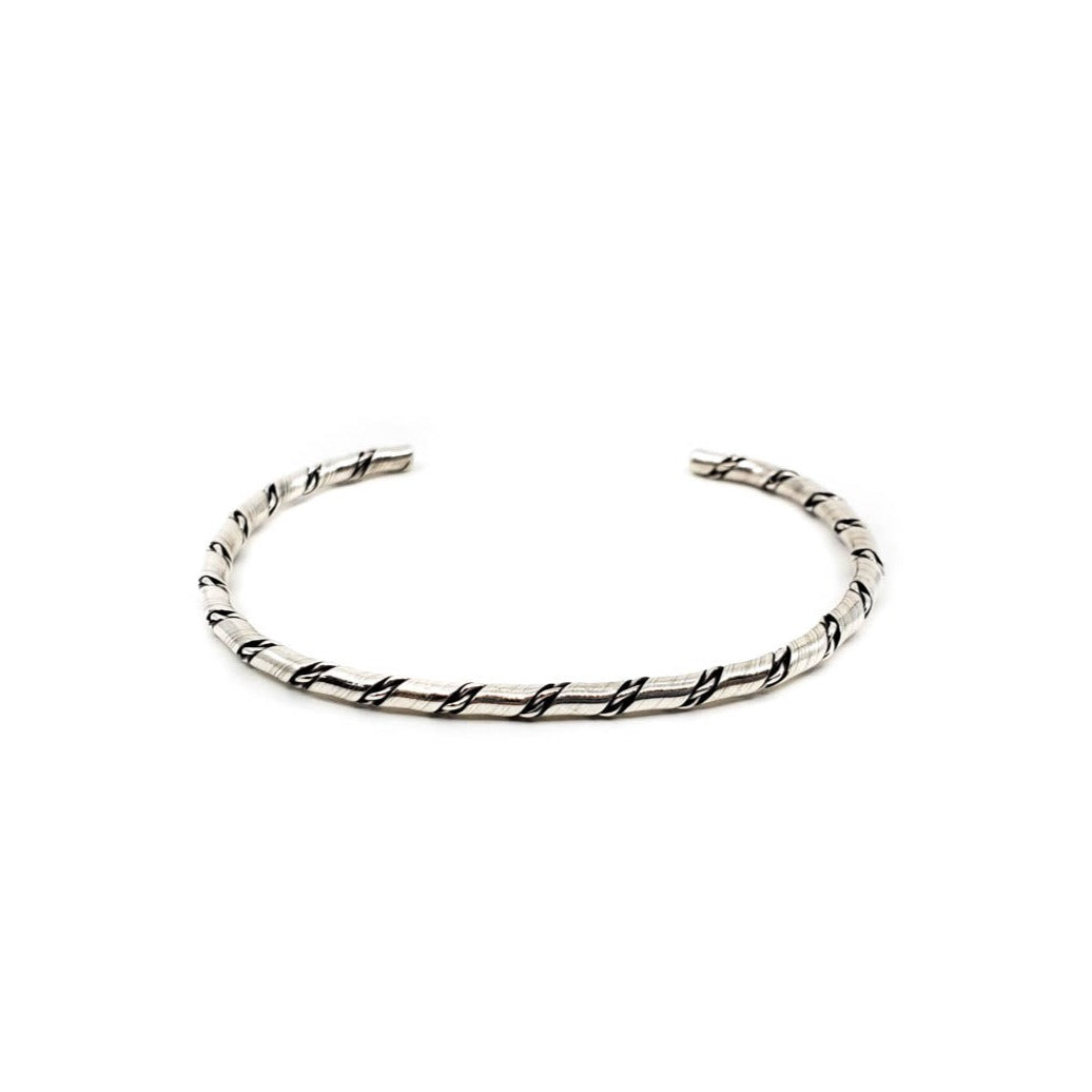 Sterling silver bracelet, classic design, great for stacking! Flattened wire intertwined with twist Lightly flexible, has some give Measures 5.5 inches plus a 1.5 inch opening - appropriate for a 6.5 to 7.5 inch wrist